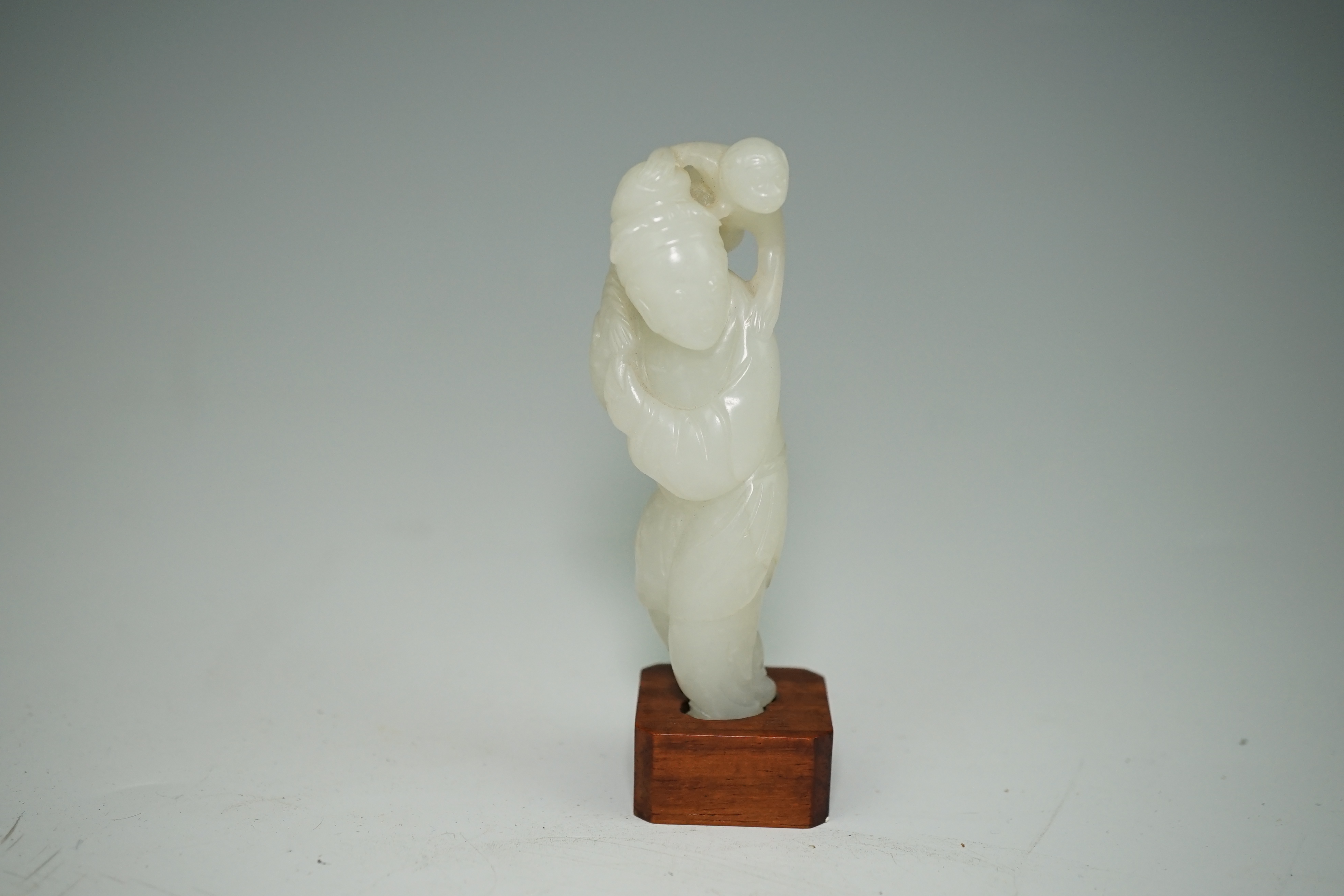 A Chinese white jade figure of a monkey trainer, 18th century